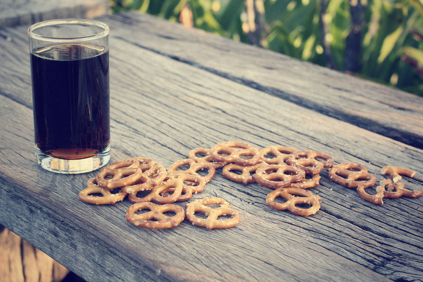 Pretzels with cola on a picnic table